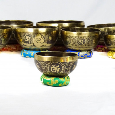 Hand hammered carved singing bowls carved with bouddhist symbols