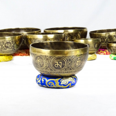 Hand hammered carved singing bowls carved with bouddhist symbols