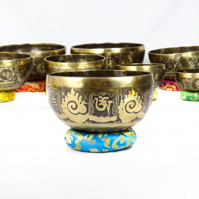 Hand hammered carved singing bowls carved with bouddhist symbols