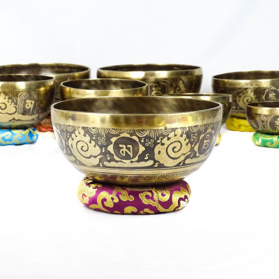 Hand hammered carved singing bowls carved with bouddhist symbols