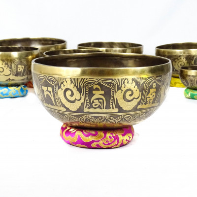 Hand hammered carved singing bowls carved with bouddhist symbols